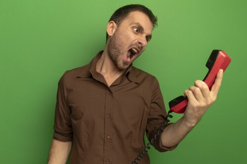 angry-young-caucasian-man-holding-old-telephone-looking-it-screaming-isolated-green-wall-1536x1024.jpeg