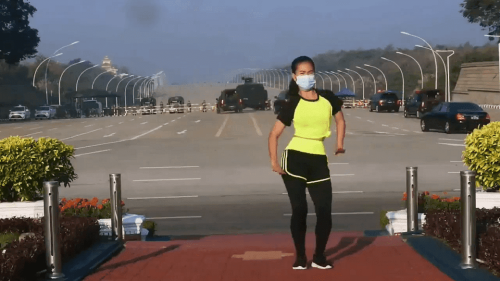 Myanmar-Aerobic-Instructor-Performs-her-Workout-Routine-with-a-Coup-Behind-Her